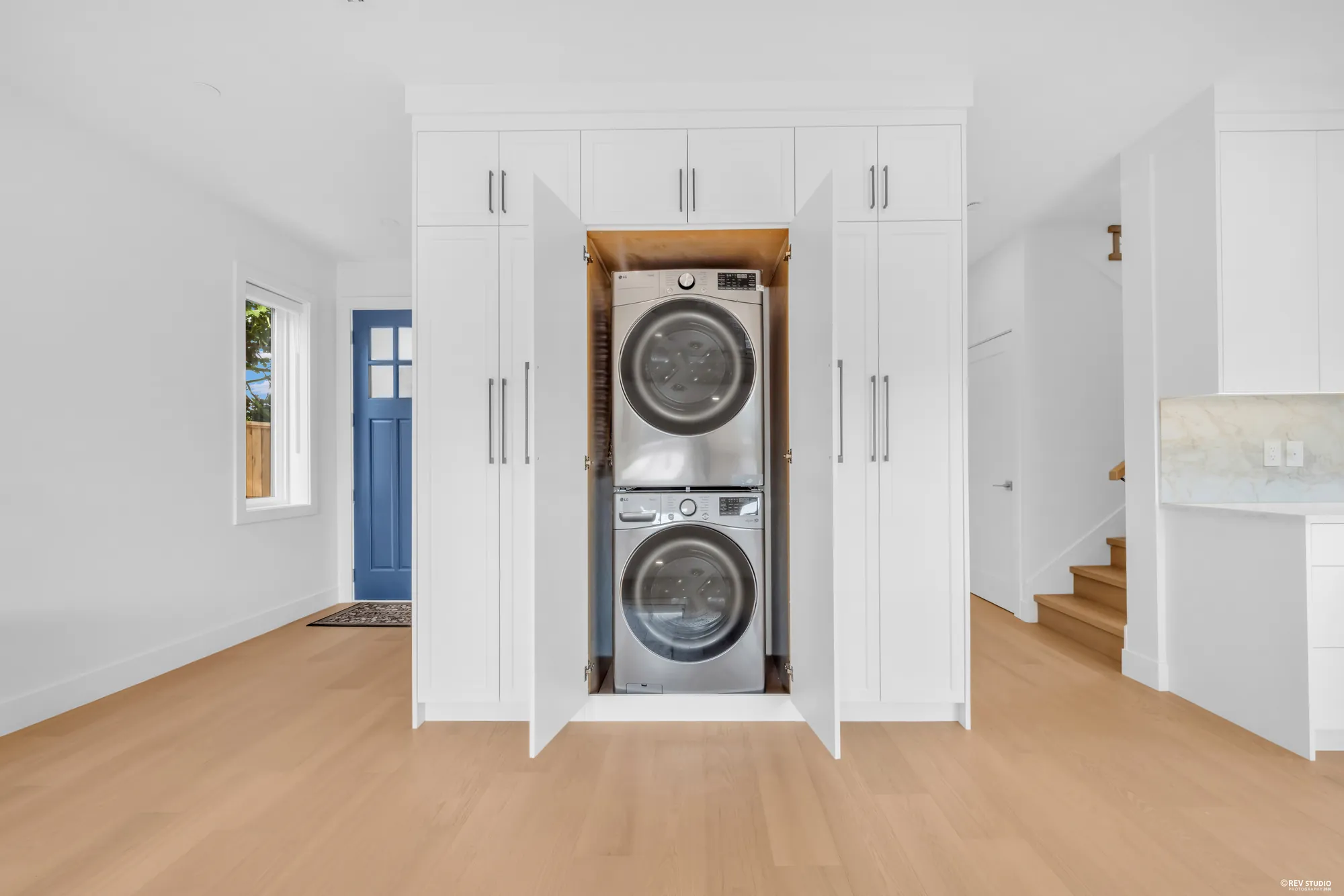 Laundry cabinet with stacked washer and dryer by the entry
