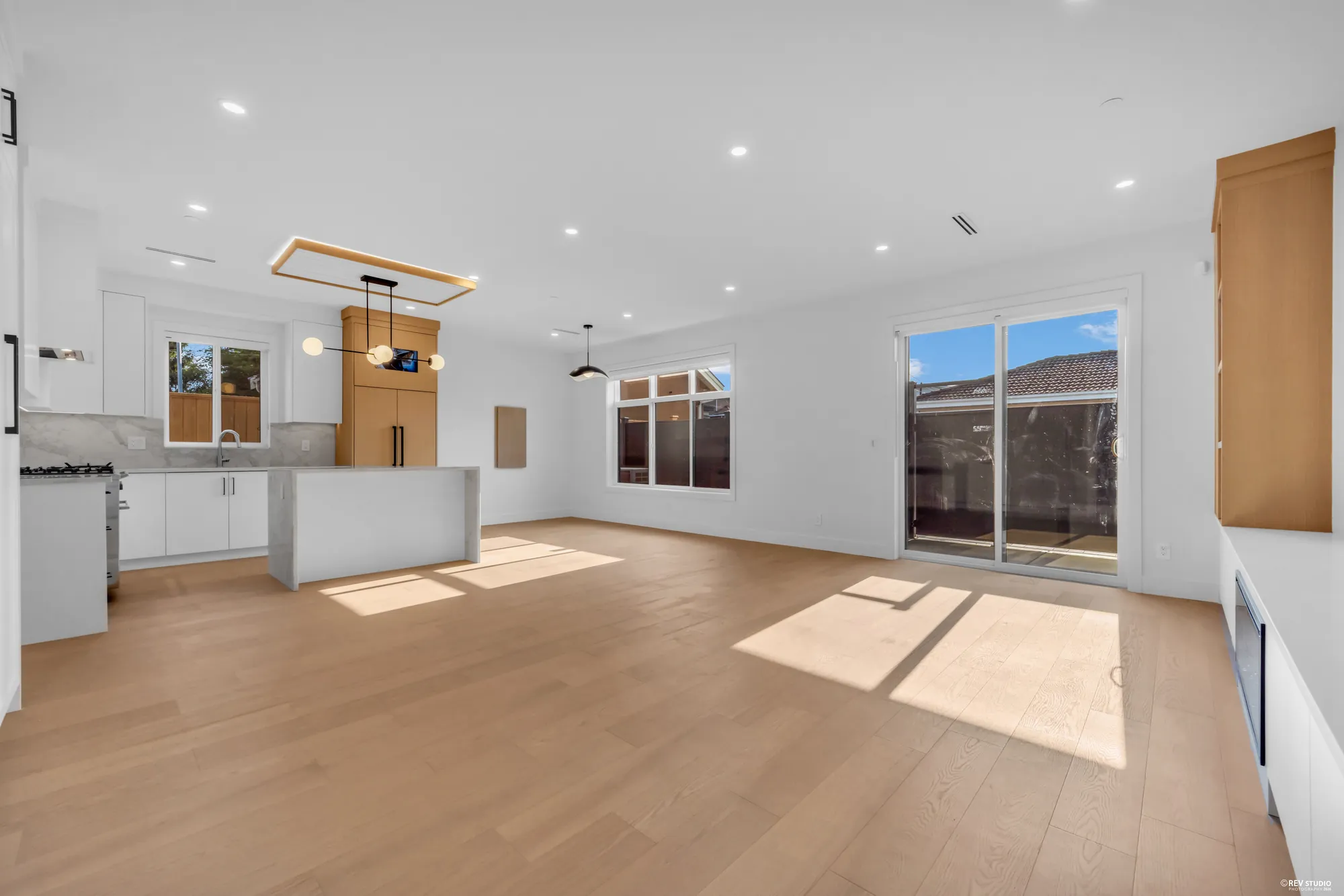 Living room looking through to the kitchen, patio doors along the side