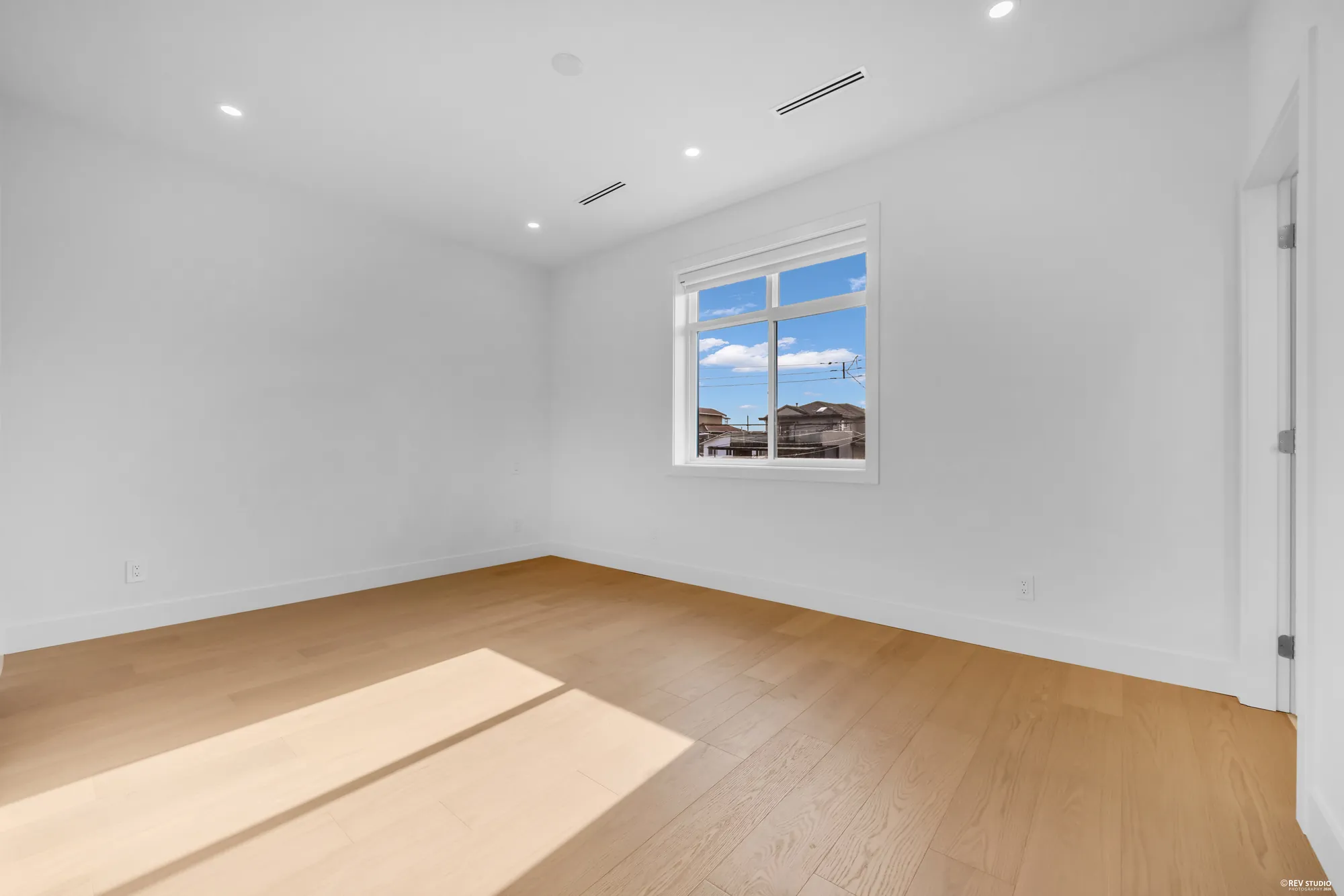 Primary bedroom with a window to the side