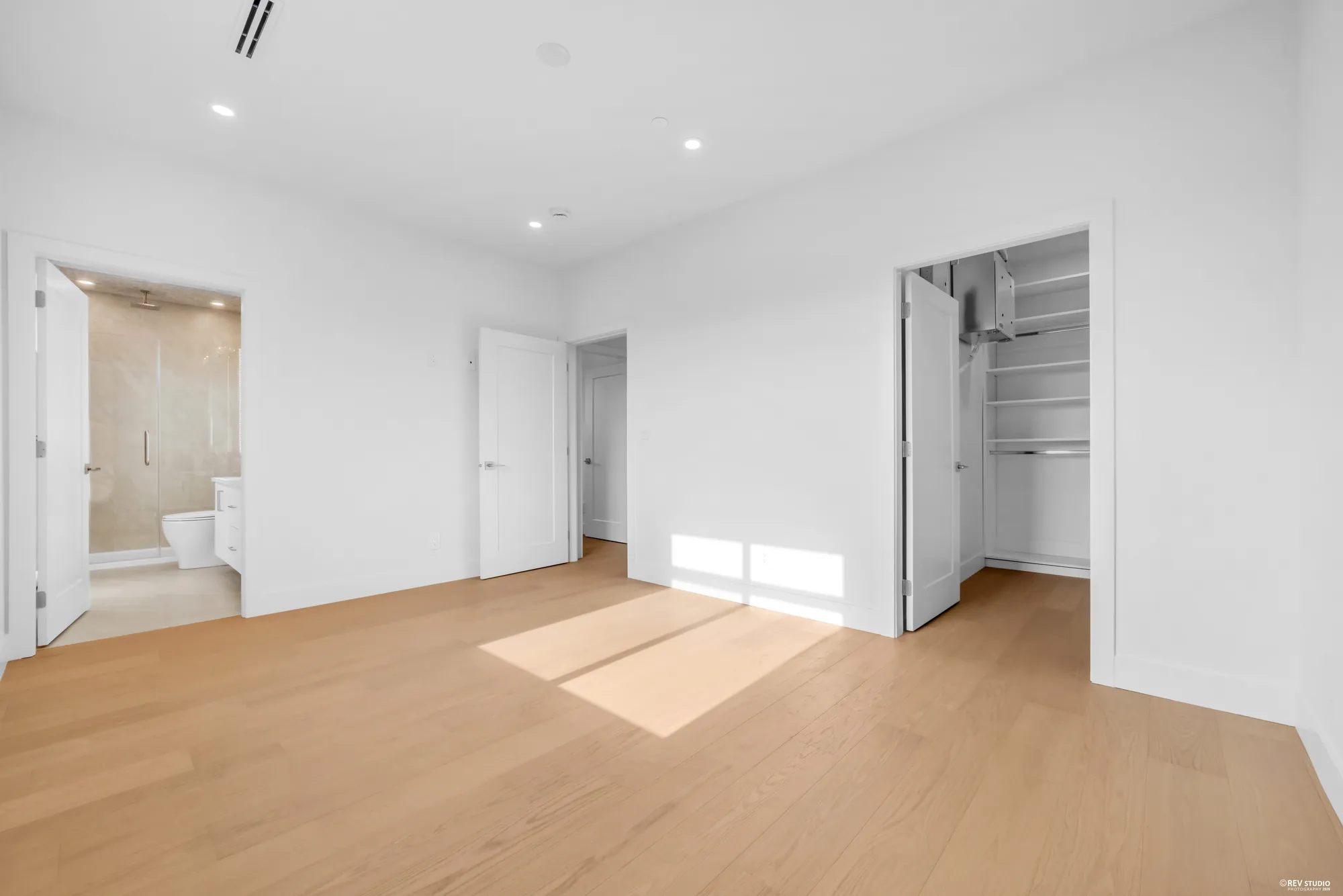 Primary bedroom toward the ensuite and walk-in closet